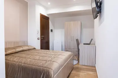 a bedroom with a bed and a television in it at Casa Vacanze del Corso in Bagheria