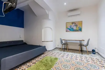 a bedroom with a bed and a table at Monolocali Leonardo in Castellammare del Golfo
