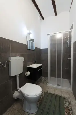 a bathroom with a toilet and a shower and a sink at Monolocali Leonardo in Castellammare del Golfo