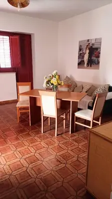 a living room with a table and chairs and a couch at LA FINESTRA SUL MARE PIANO Terra in Trappeto