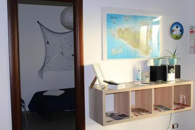 a room with a mirror and a table with a laptop at La Casa di Andly in Palermo