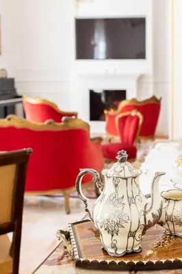 a room with a table with two tea pots and chairs at Le Rose di Nonna Maria, appartamento di lusso in centro città in Palermo