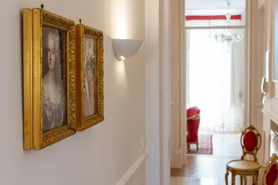 a hallway with two framed pictures on a wall at Le Rose di Nonna Maria, appartamento di lusso in centro città in Palermo
