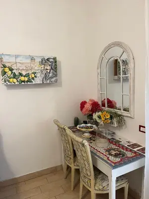 a dining room with a table and a mirror at La Siciliana-di fronte la Cattedrale in Palermo