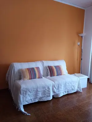 a white couch with two pillows in a room at Casa Rosamarina in Mondello