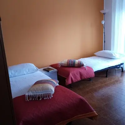 a room with two beds and a window at Casa Rosamarina in Mondello