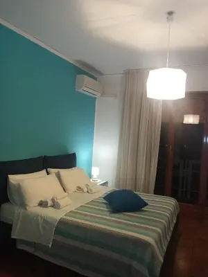 a bedroom with a bed with a blue wall at Casa Rosamarina in Mondello