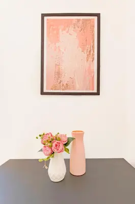 two vases sitting on a table with flowers at La Ciconella in Palermo