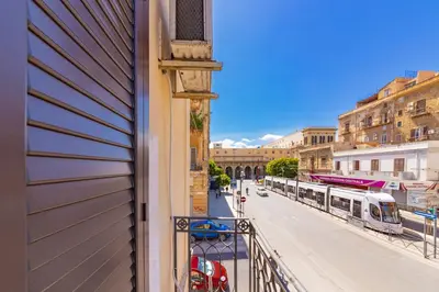 a view from a balcony of a street with a train at La Ciconella in Palermo
