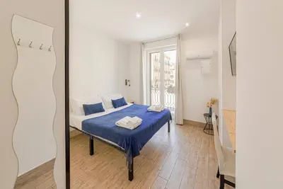 a bedroom with a bed and a mirror at La Ciconella in Palermo