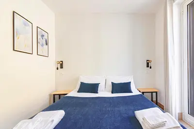 a bedroom with a blue and white bed with two pillows at La Ciconella in Palermo