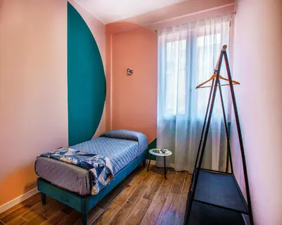 a room with a bed and a tripod next to a window at Casa del Capo in Palermo
