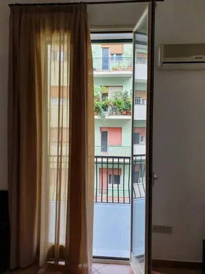 a window with a view of a building at Le stanze di Ruggero in Palermo