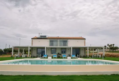 a house with a pool in front of it at Case Playa Resort in Balestrate