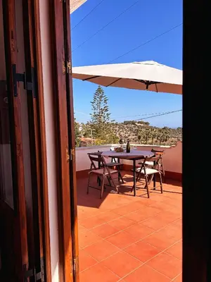 a patio with a table and an umbrella at Casa Villea in Trabia