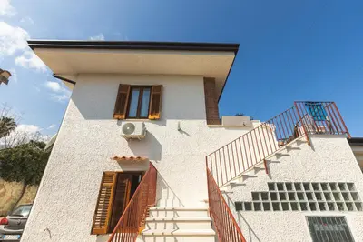 a building with stairs on the side of it at Casa Villea in Trabia
