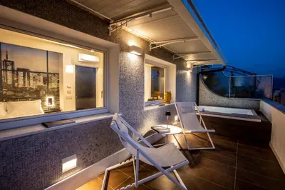 a balcony with two chairs and a window at Miceli Exclusive Suite in Palermo