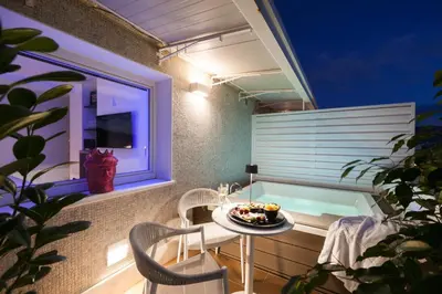 a balcony with a table and chairs and a window at Miceli Exclusive Suite in Palermo