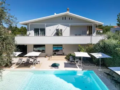 a house with a swimming pool in front of a house at Domìa Boutique Hotel e Cucina in Mondello