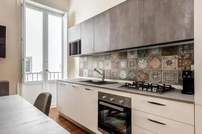 a kitchen with a stove top oven next to a window at Anna's Luxury Apartment in Palermo