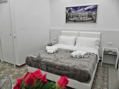 a bedroom with a bed with two stuffed animals on it at Ai Quartieri in Palermo