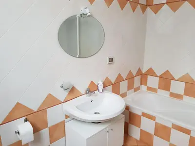 a bathroom with a sink and a mirror and a tub at Stanze Di Leo in Palermo
