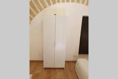 a white cabinet in a room with a couch at Appartamento VITTORIA in Palermo