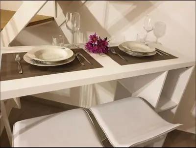 a white table with two plates and glasses on it at Appartamento VITTORIA in Palermo