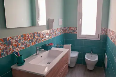 a bathroom with a sink and a toilet at B&B Rainbow in Campofelice di Roccella