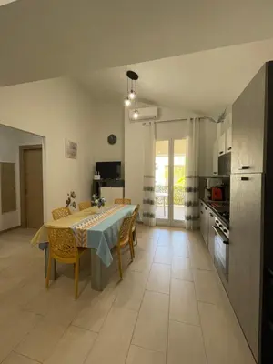 a kitchen and dining room with a table and chairs at Casa vacanza 