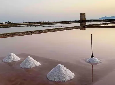 three piles of sand in a body of water with an umbrella at Curina Luxury Villa - Panoramic Pool Villa near Scopello in Castellammare del Golfo