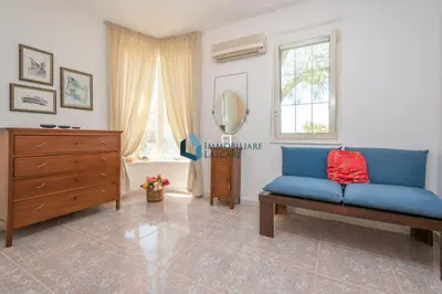 a living room with a blue couch and a dresser at Villa Panorama in Cefalù