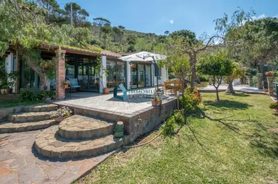a home with a stone patio and a building at Villa Panorama in Cefalù