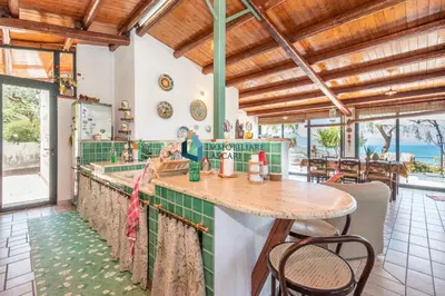a kitchen with a counter with green tiles at Villa Panorama in Cefalù