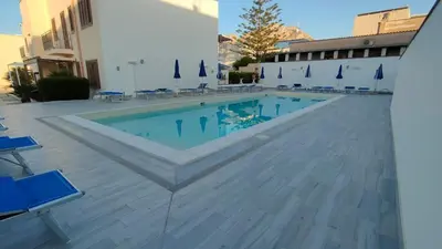 a swimming pool in the middle of a building at Stella del Mare San Vito Lo Capo in San Vito lo Capo