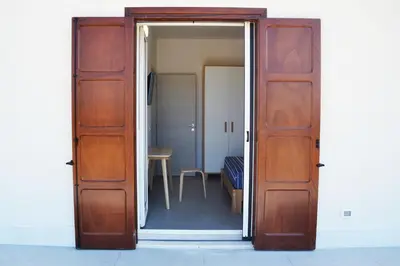an open door leading to a room with a table at Splendida Villa NATURE-APPARTAMENTO MELOGRANO a SCOPELLO-ZINGARO vista sul mare in Scopello