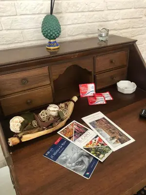 a wooden table with books and magazines on it at nonno peppe in Palermo