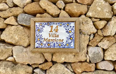 a picture in a frame on a stone wall at Villa Marcione Garden & House in Cinisi