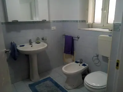 a bathroom with a toilet and a sink at La Casetta di Dafne in Palermo