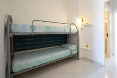 a couple of bunk beds in a room at APPARTAMENTI BLUSANVITO P-TERRA in San Vito lo Capo