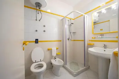 a bathroom with a toilet and a shower and a sink at APPARTAMENTI BLUSANVITO P-TERRA in San Vito lo Capo