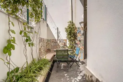 a courtyard with chairs and plants in a building at L'Angolino di Anna in Mondello