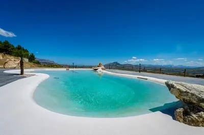 a swimming pool with a view of the ocean at Agriturismo Antichi Granai in Calatafimi