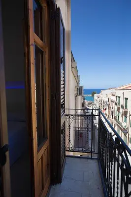 an open door to a balcony with a view at Casa in centro in Castellammare del Golfo