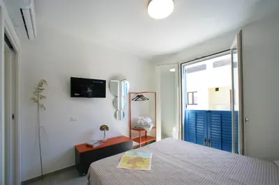a bedroom with a bed and a large window at ITACA e MEDEA - Appartamenti con idromassaggio in terrazza in San Vito lo Capo