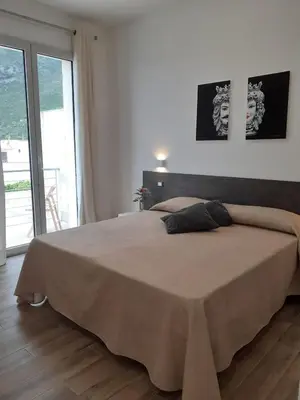 a bedroom with a large bed with a large window at Bed and Breakfast Stella del Sud Makari in Macari