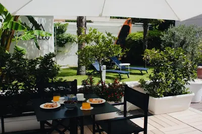 a table with plates of food on it in a garden at AWA Mondello in Mondello