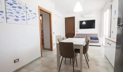 a kitchen and dining room with a table and chairs at Sea Vito Apartment in San Vito lo Capo