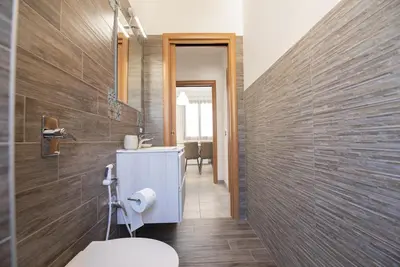 a bathroom with a sink and a toilet in it at Sea Vito Apartment in San Vito lo Capo
