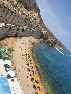 an aerial view of a beach with umbrellas and the ocean at Casa vacanza Corallo in Castellammare del Golfo
